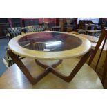 A Stonehill Stateroom teak and glass topped circular coffee table