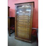 A Victorian mahogany museum collectors cabinet, with single glazed door revealing thirteen drawers