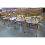 A set of four Ercol green dot beech stacking chairs