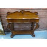 A Victorian carved oak serpentine single drawer hall table