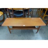 A teak concave ended coffee table