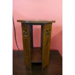 An Arts and Crafts oak jardiniere stand