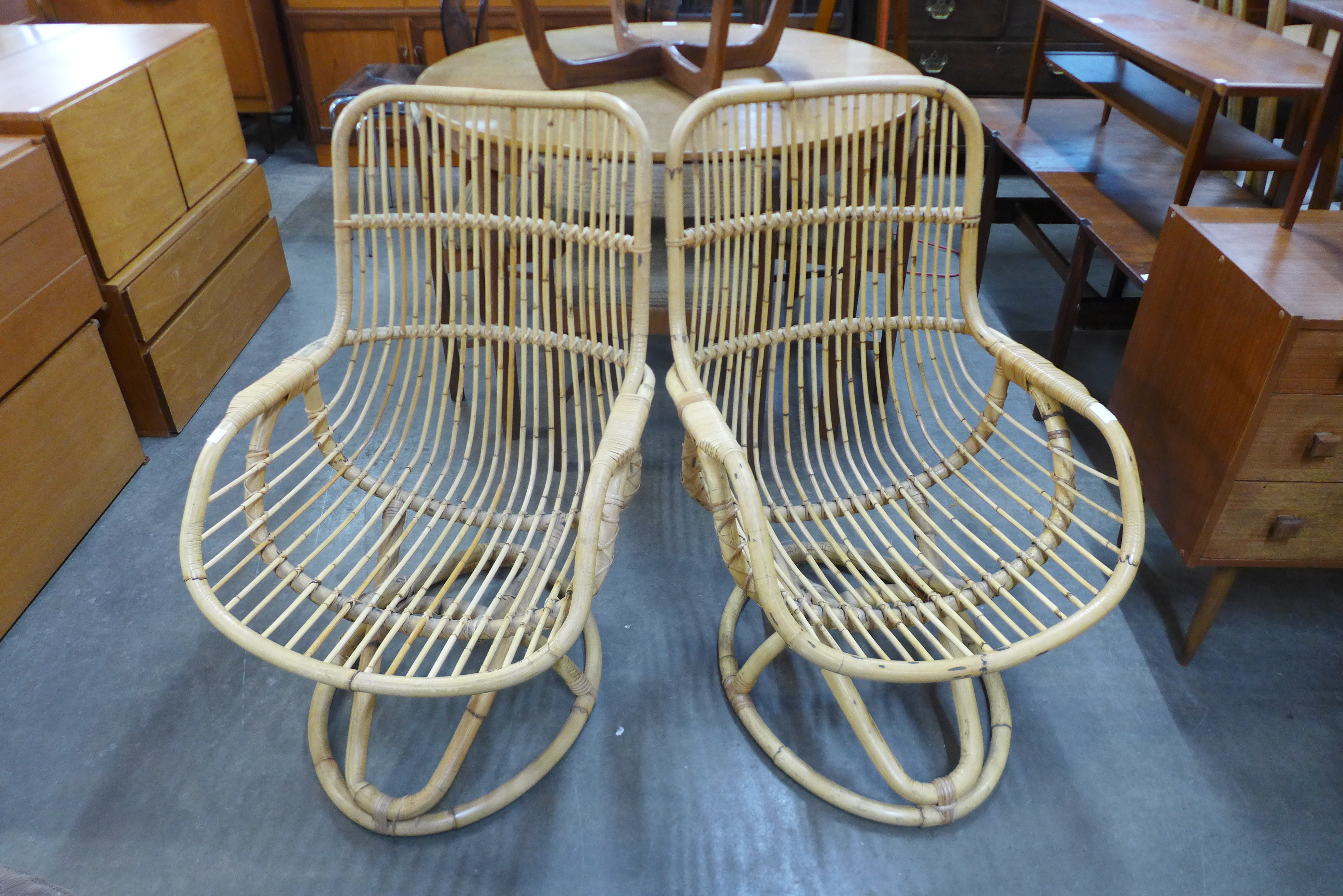 A pair of bamboo lounge chairs