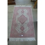 A small Turkish silk pink ground rug