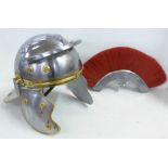 A replica Roman metal helmet with crest