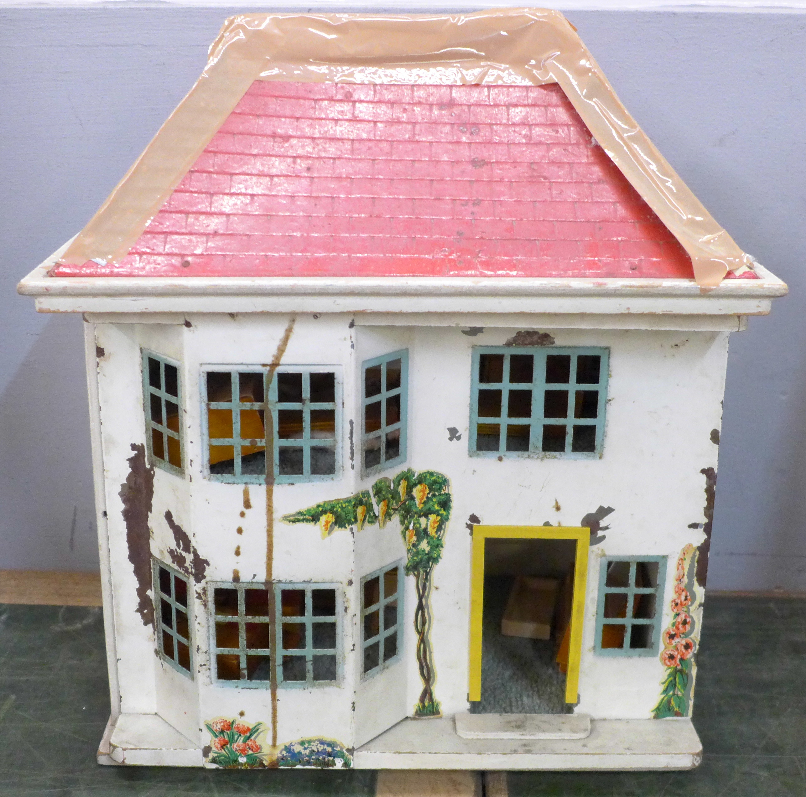 A tin plate and wooden doll's house with furniture, 41cm, roof a/f