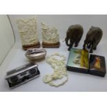 Two lacquered boxes, a pair of pocket binoculars, a table lighter, two resin sculptures, resin