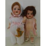 Two dolls; a German Heubach bisque head doll with pale blue sleep eyes, 500 14/0 identification