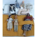 A collection of small dolls and two dolls arms