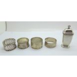 Four silver napkin rings, two a/f, and a silver pepper, 115g