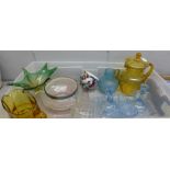 A collection of coloured glass including an Art Deco blue dressing table set, two amber jugs, two