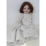 A German Hertel Schwab bisque head doll with brown sleep eyes, 152-2 identification marks, circa