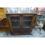 A small carved oak linenfold two door bookcase