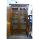 An Old Charm carved oak linenfold four door cabinet