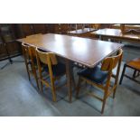 A teak extending dining table and six chairs