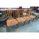 A set of four teak dining chairs