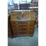 A George III style inlaid mahogany bureau