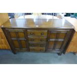 An Ercol dark elm and beech sideboard