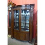 A Hepplewhite Revival carved mahogany two door bow front side cabinet