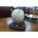 A table top terrestrial globe and a World Atlas