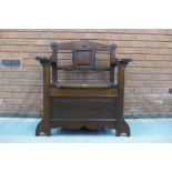 An Arts and Crafts oak hall seat