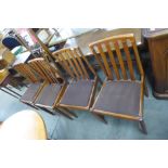 A set of four teak dining chairs