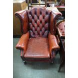 A red leather wingback armchair, a/f