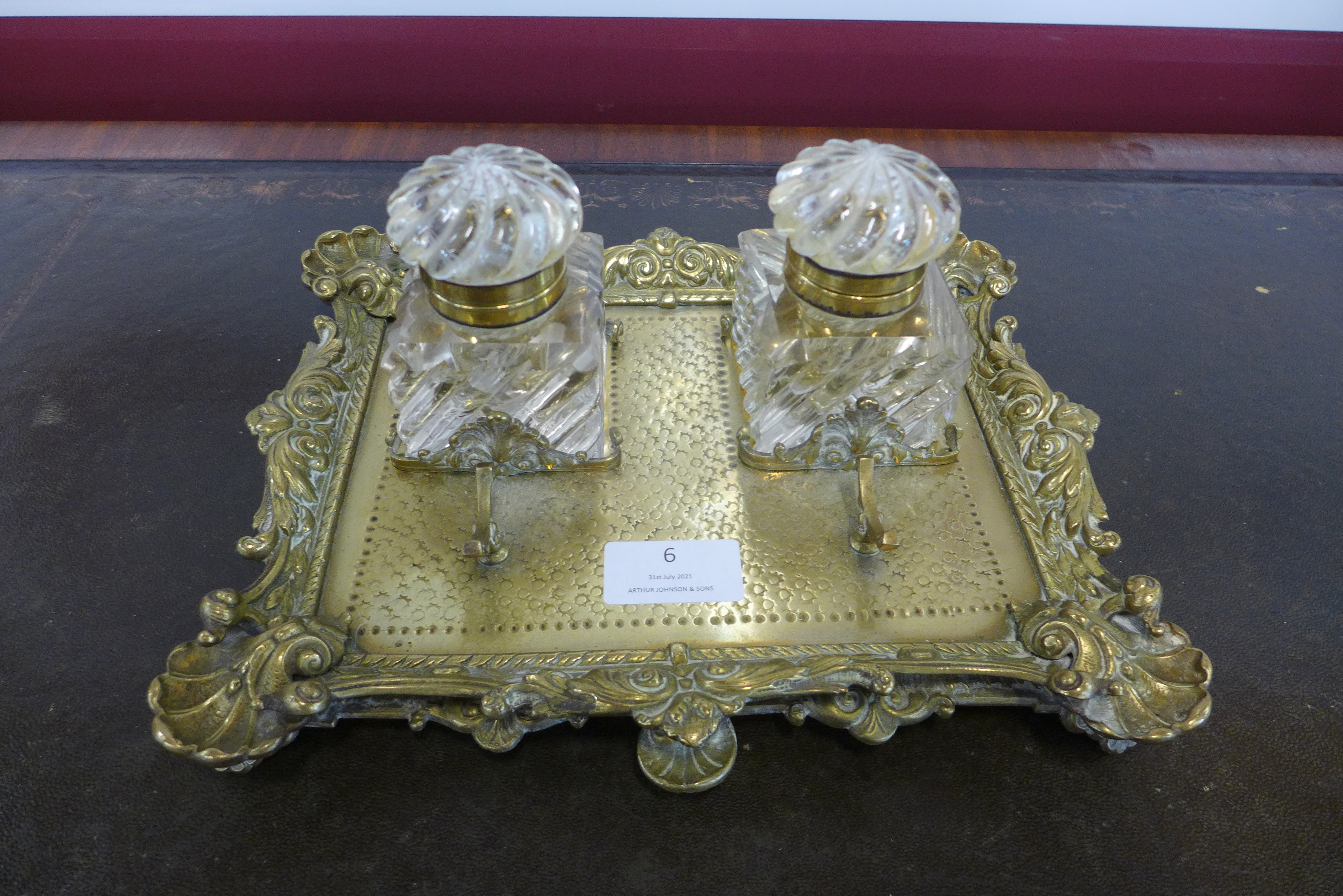 A Victorian ormolu desk stand, with two cut glass inkwells
