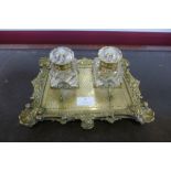 A Victorian ormolu desk stand, with two cut glass inkwells