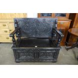 A Jacobean Revival carved oak monk's bench