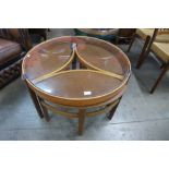 A Nathan teak and glass topped circular nest of tables