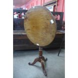 A George III oak and mahogany circular tilt top tripod table