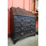 A Victorian Jacobean Revival carved oak bureau