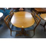 A Nathan teak extending dining table and four chairs