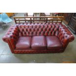 A red leather Chesterfield settee