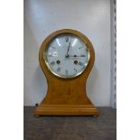 A Franz Hermle maple balloon shaped mantel clock