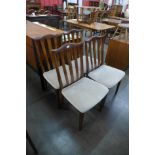 A set of four teak dining chairs