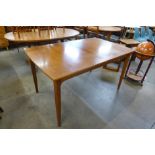 A teak extending dining table