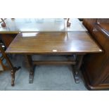 A Cotswold School oak single drawer writing table