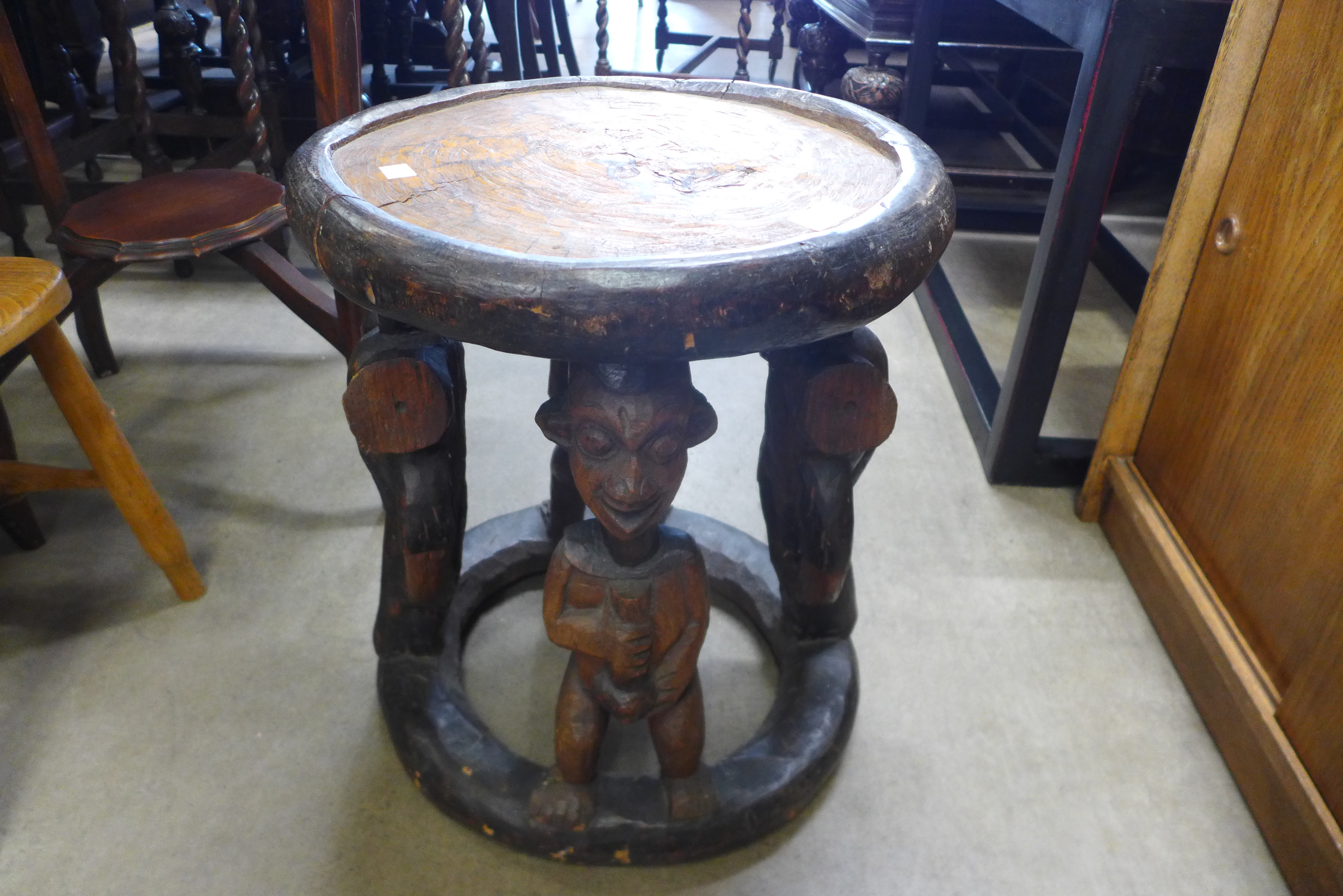 An African carved softwood occasional table