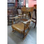 An American Arts and Crafts carved oak rocking chair