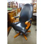 A beech and black leather revolving desk chair