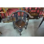 A 17th Century style carved oak corner elbow chair