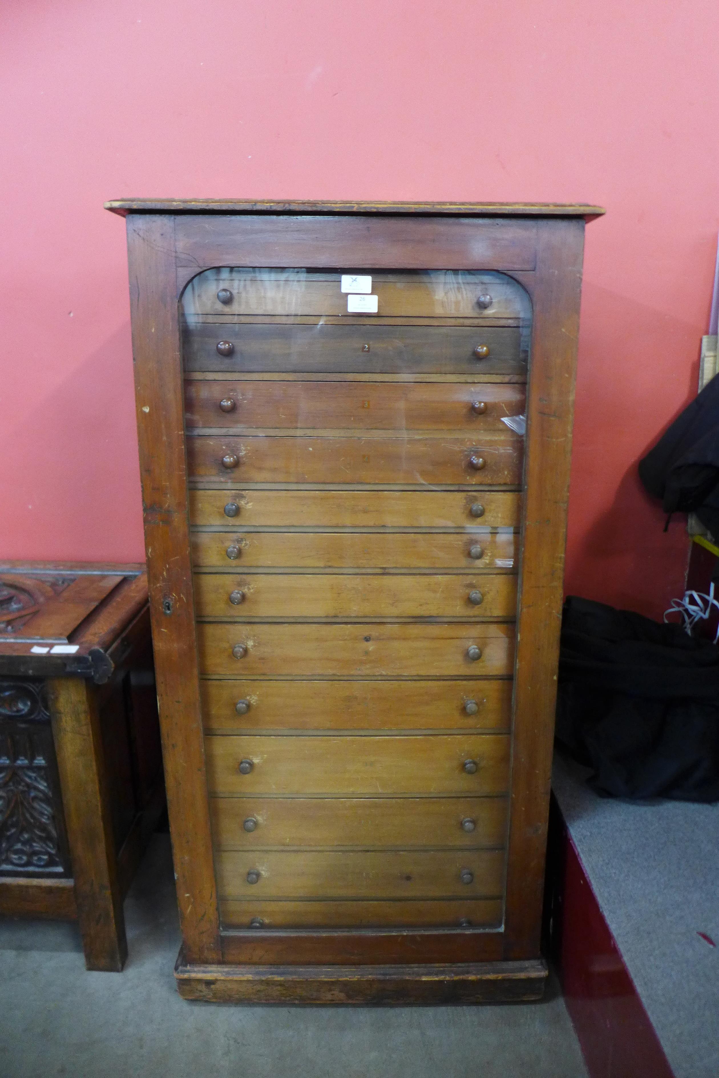 A Victorian mahogany museum collectors cabinet, with single glazed door revealing thirteen drawers