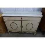 An Italian cream painted, gilt metal mounted and marble topped commode