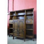 An Arts and Crafts oak open breakfront bookcase