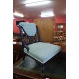 A Victorian Aesthetic Movement ebonised and upholstered nursing chair