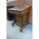 A Victorian rosewood sliding top Davenport, stamped James Winter, 101 Wardour St., London