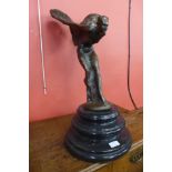 A bronze Spirit of Ecstasy, on black marble socle