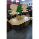 A chrome and beech table and six chairs